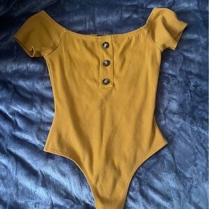 yellow body suit